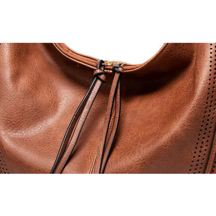 Borsa a tracolla da donna, pratica e spaziosa, con design moderno in velluto a coste e nappine decorative.