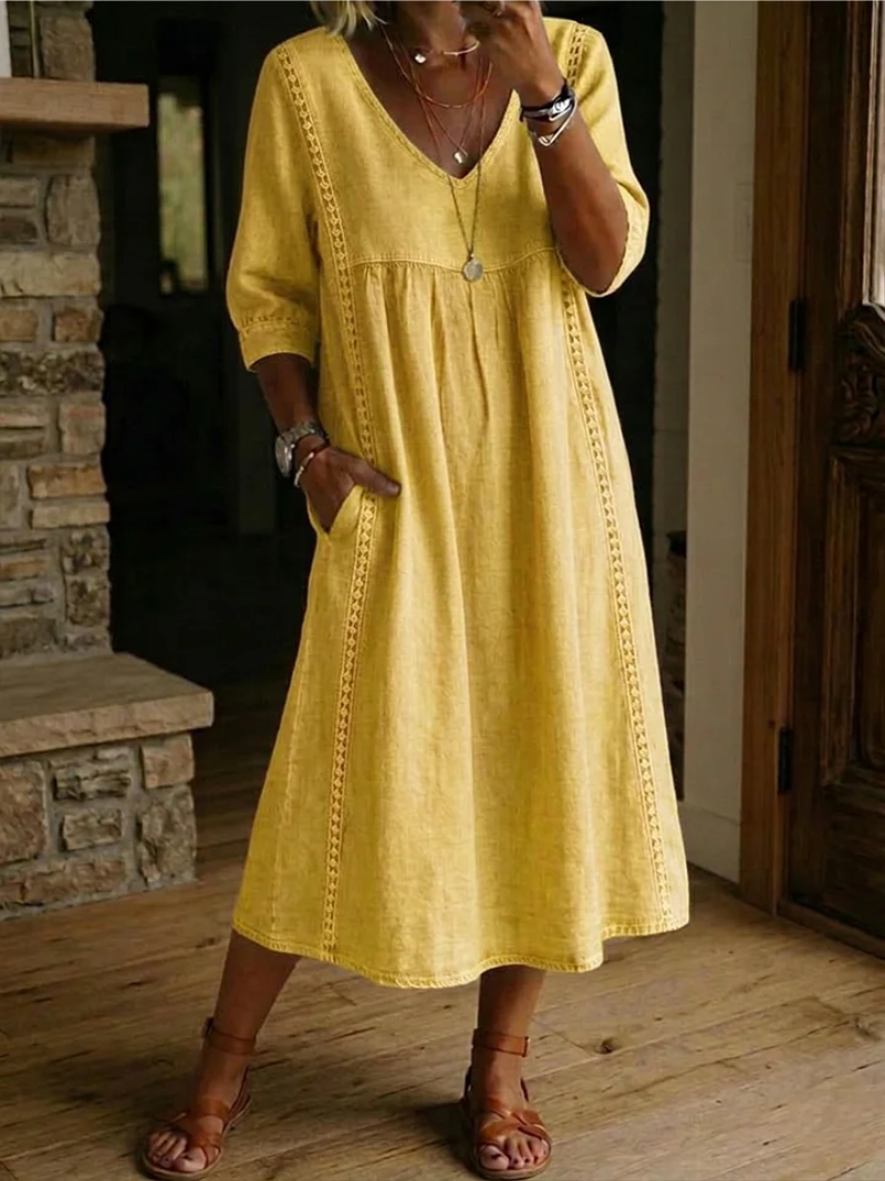 Abito midi casual da donna con tasche, design morbido e fluido, perfetto per il quotidiano e un comfort femminile.