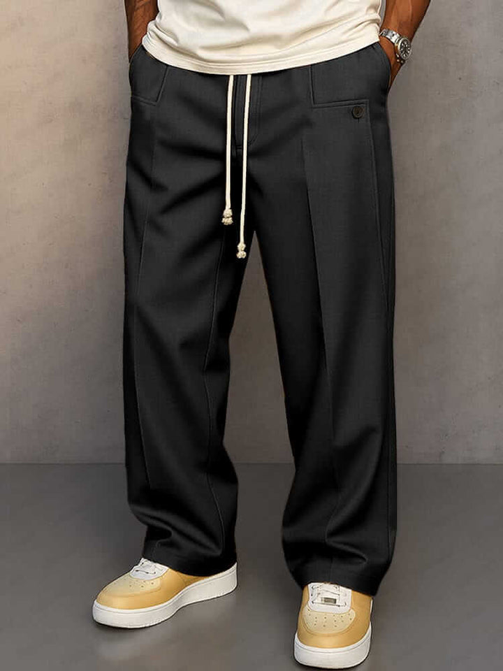 Pantaloni grigi da uomo, modello largo e comodo. Coulisse in vita e ampie tasche laterali per comfort elevato.