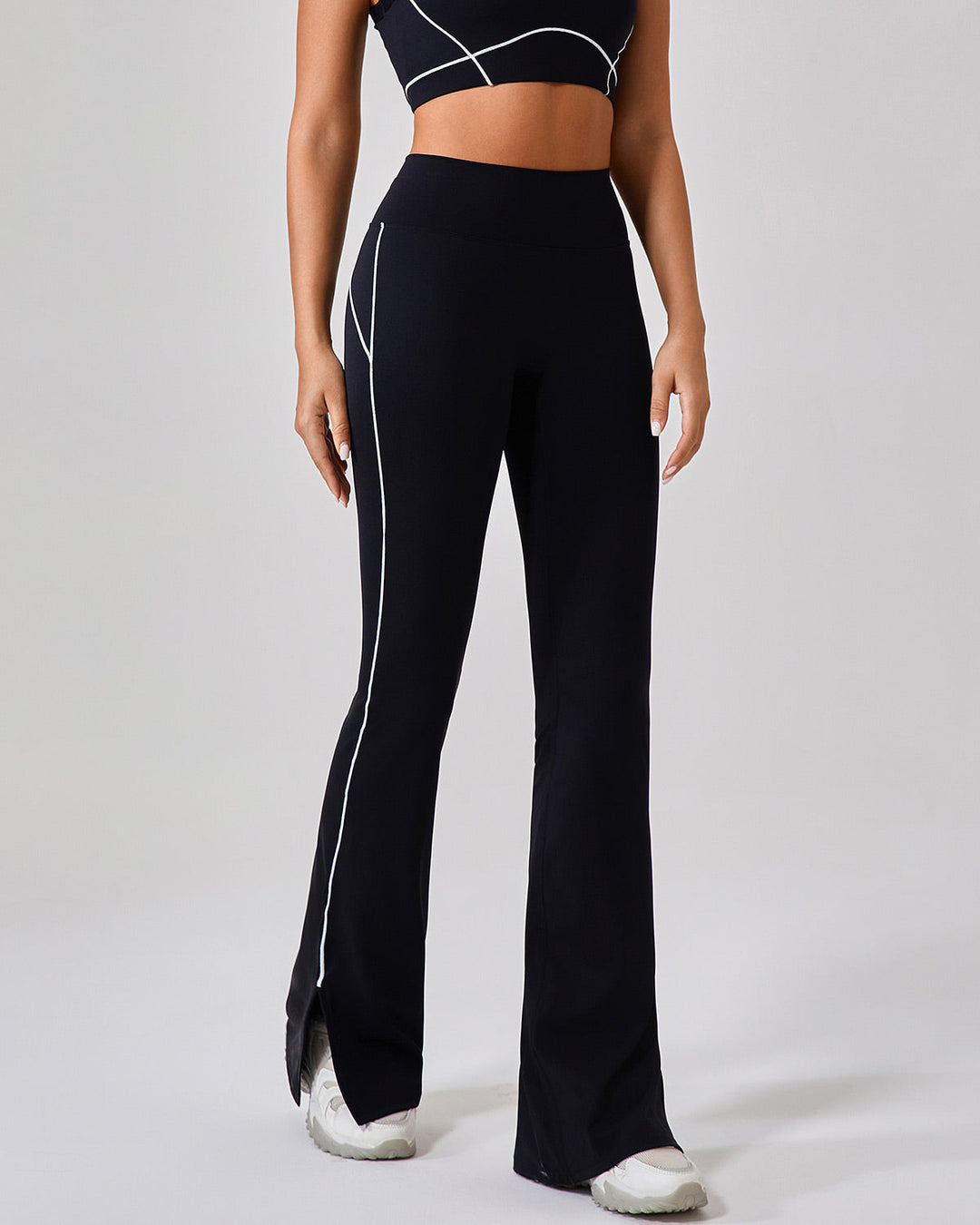 Leggings donna a vita alta, svasati sul fondo, con spacco e piping a contrasto per abbigliamento sportivo.