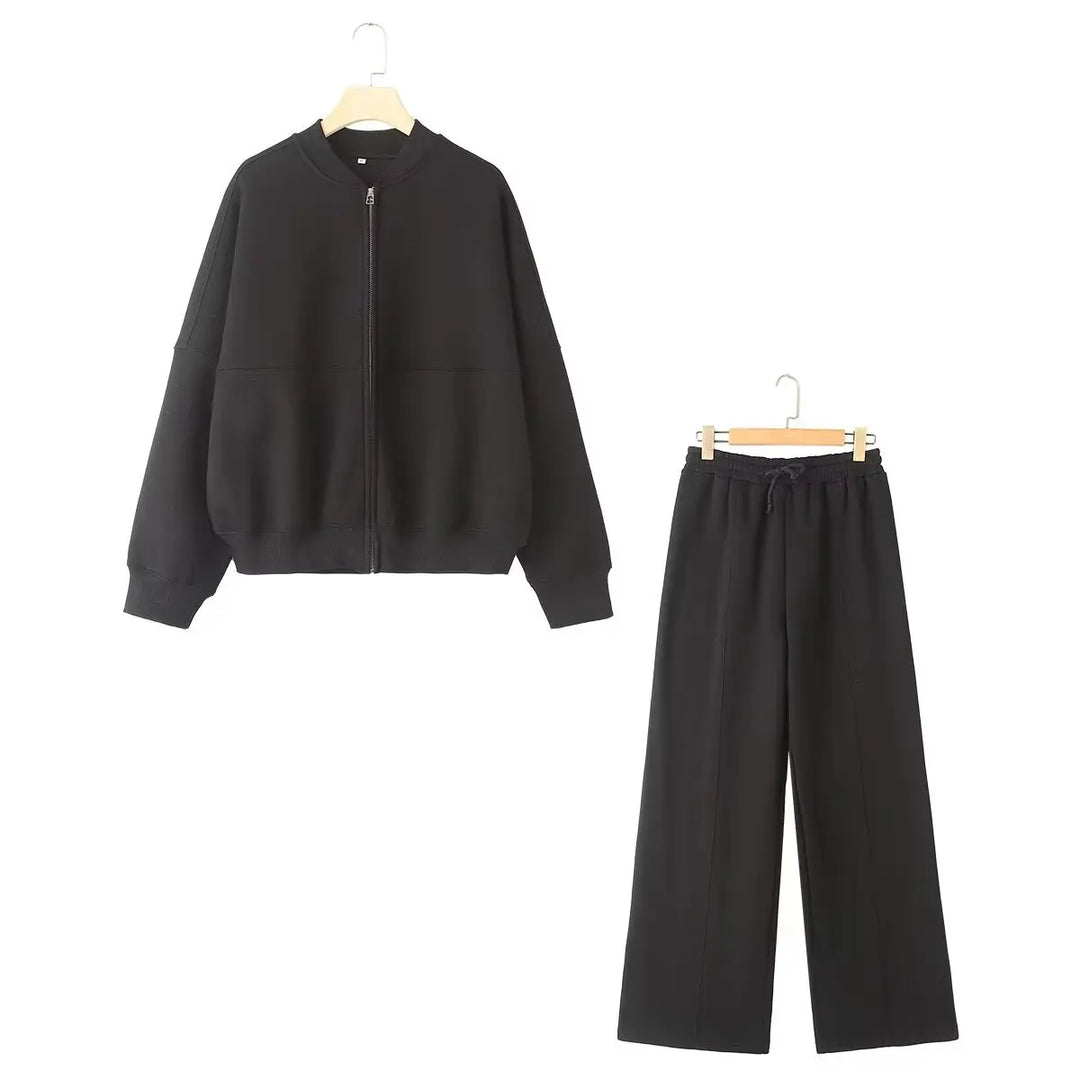 Top donna a maniche lunghe con zip e pantaloni a vita alta gamba larga. Completo due pezzi ideale per comfort e stile casual.