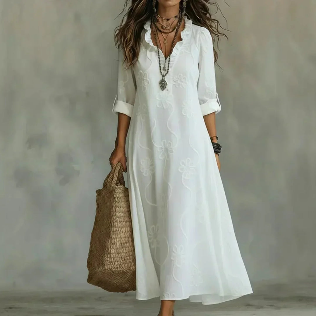 Abito lungo donna stile boho, ricamo floreale vivace e scollo a V. Perfetto per un look casual chic estivo.