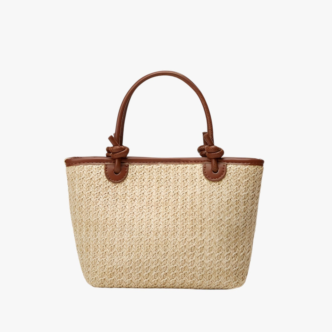 Borsa da donna in paglia intrecciata naturale con robusti manici, perfetta come accessorio estivo.
