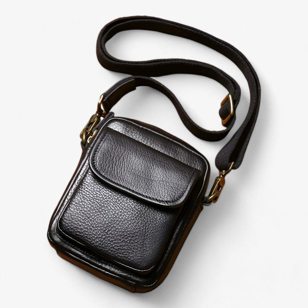 Borsa a tracolla uomo nera elegante e compatta, ideale per viaggi e come accessorio quotidiano.