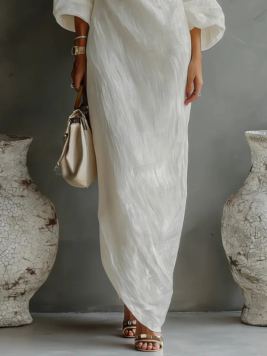 Elegante abito lungo donna nero monospalla, con orlo asimmetrico e pratiche tasche laterali.