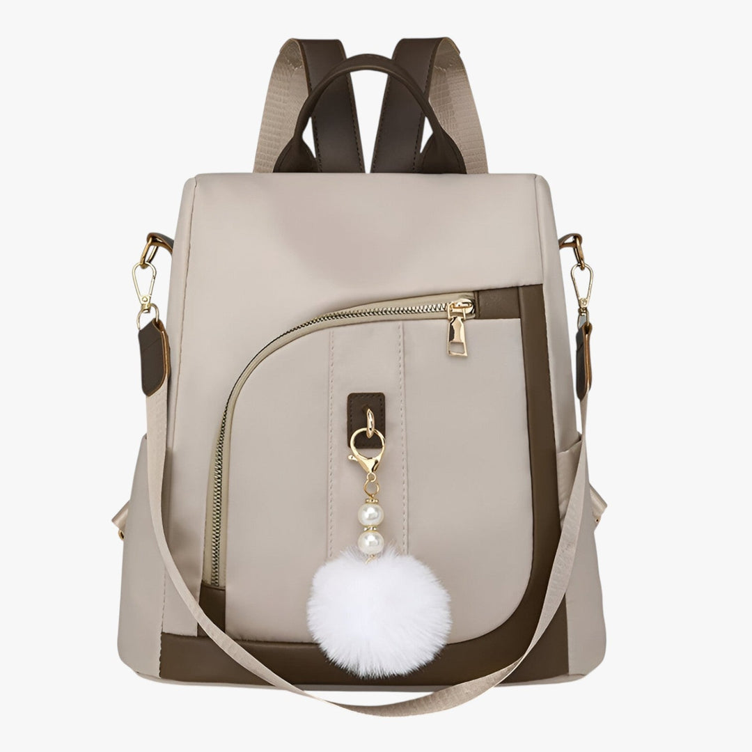 Zaino borsa donna versatile con pompon rimovibile, perfetto per ogni stile e occasione, disponibile in beige.