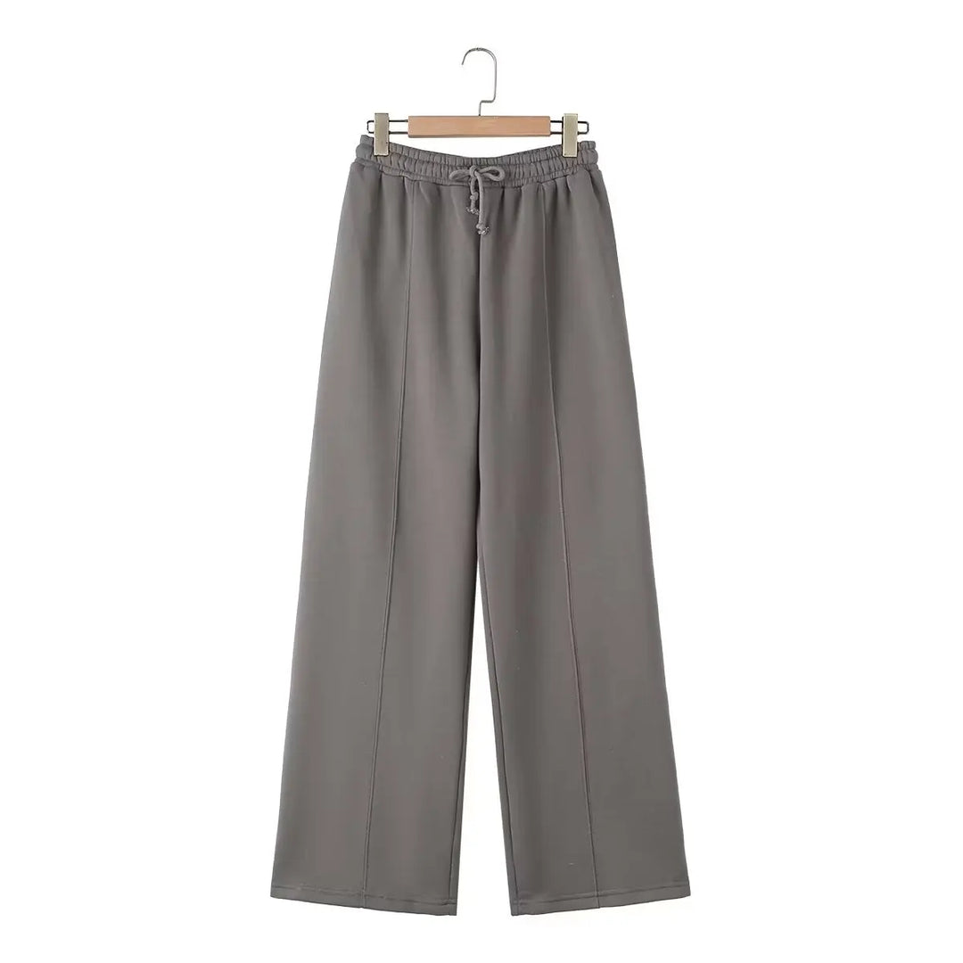 Moda donna: completo due pezzi con top zip e pantaloni a vita alta gamba larga, perfetto per un abbigliamento casual e stiloso.