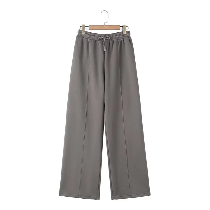 Moda donna: completo due pezzi con top zip e pantaloni a vita alta gamba larga, perfetto per un abbigliamento casual e stiloso.