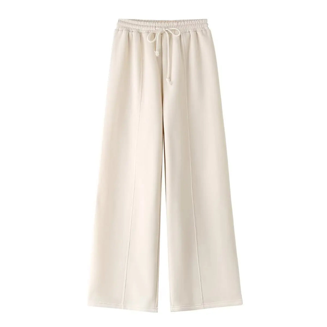 Completo due pezzi donna con top a zip manica lunga e pantaloni ampi a vita alta, per un comfort elevato e un look moderno.