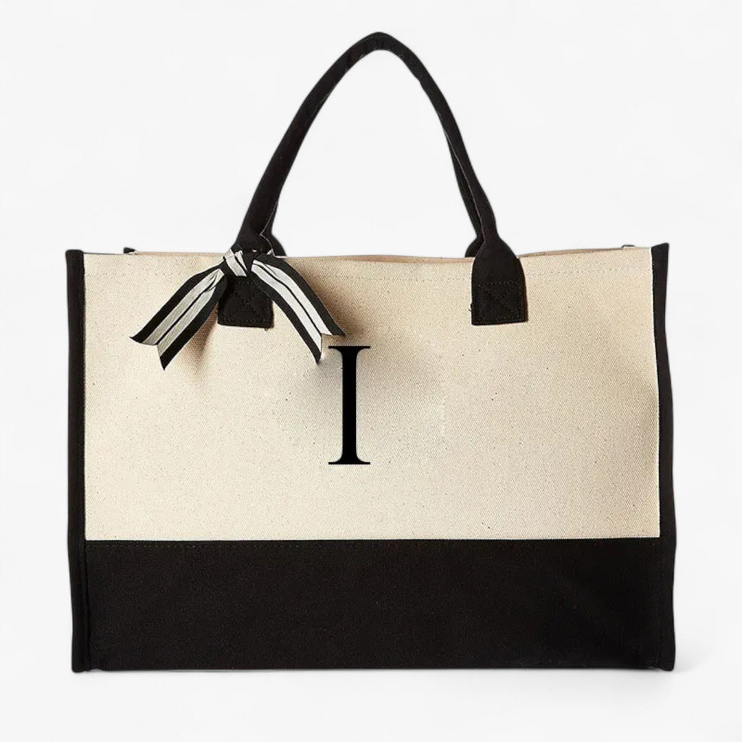 Borsa tote donna personalizzabile beige e nera con iniziale. Elegante accessorio versatile per il quotidiano.