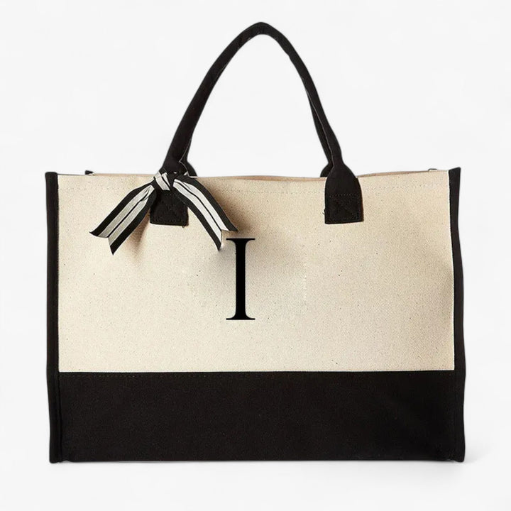 Borsa tote donna personalizzabile beige e nera con iniziale. Elegante accessorio versatile per il quotidiano.