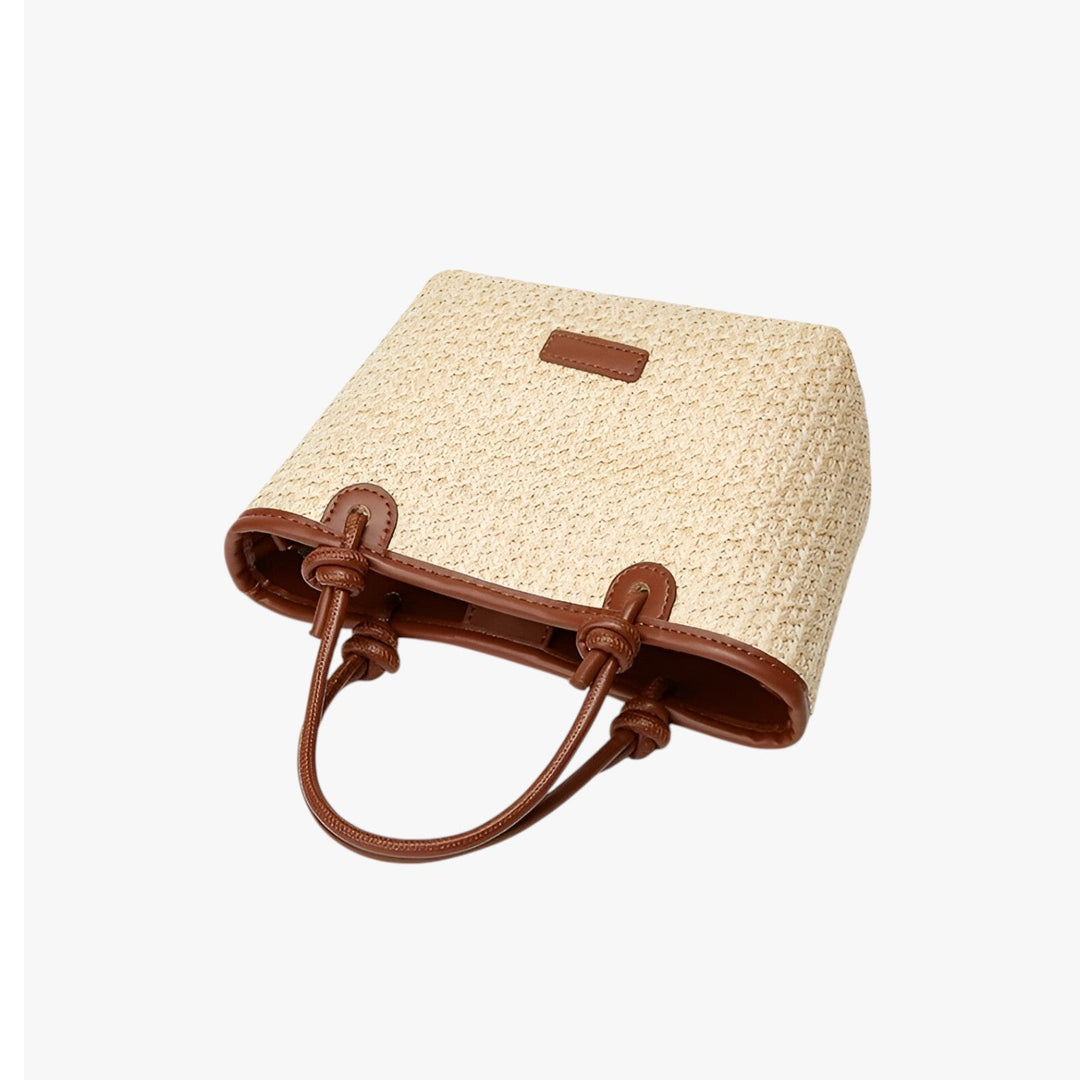 Elegante borsa tote da donna in paglia intrecciata, accessorio casual estivo e versatile.