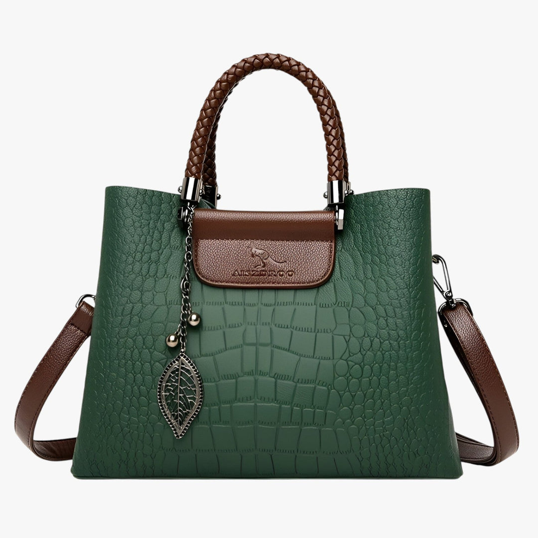 Primo piano texture coccodrillo su borsa tote marrone da donna, raffinato e di tendenza.