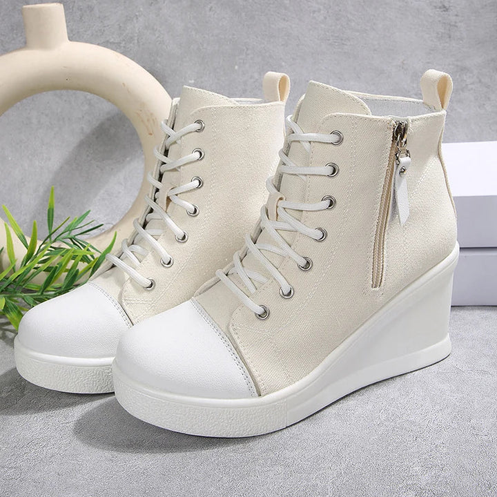 Sneakers da donna con zeppa alta, zip laterale e lacci frontali, per un look deciso e alla moda.
