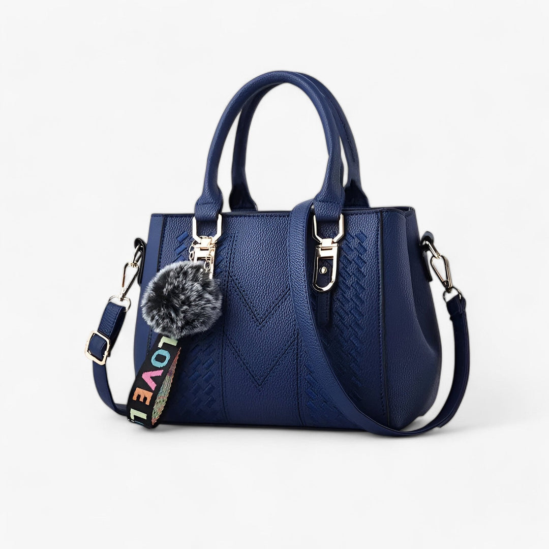 Borsa a mano donna con pratica tracolla regolabile e pompon, ideale per avere le mani libere.
