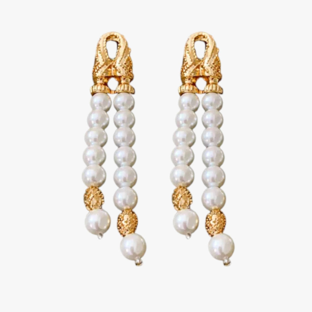 Orecchini pendenti donna in oro con elegante elemento sferico, gioielli moda versatili.