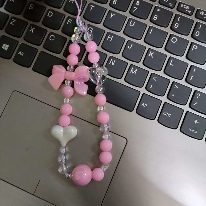 Laccetto smartphone donna con perline macaron pastello e fiore, un accessorio dolce e raffinato da polso.