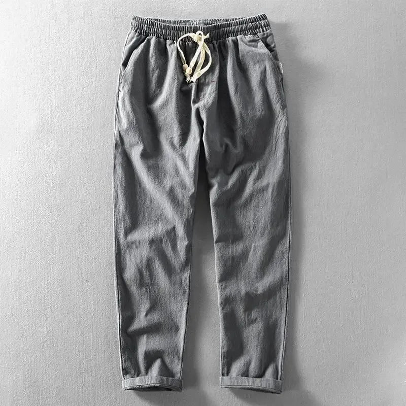 Uomo indossa pantaloni in lino, stile rilassato e confortevole, perfetti per il clima estivo.
