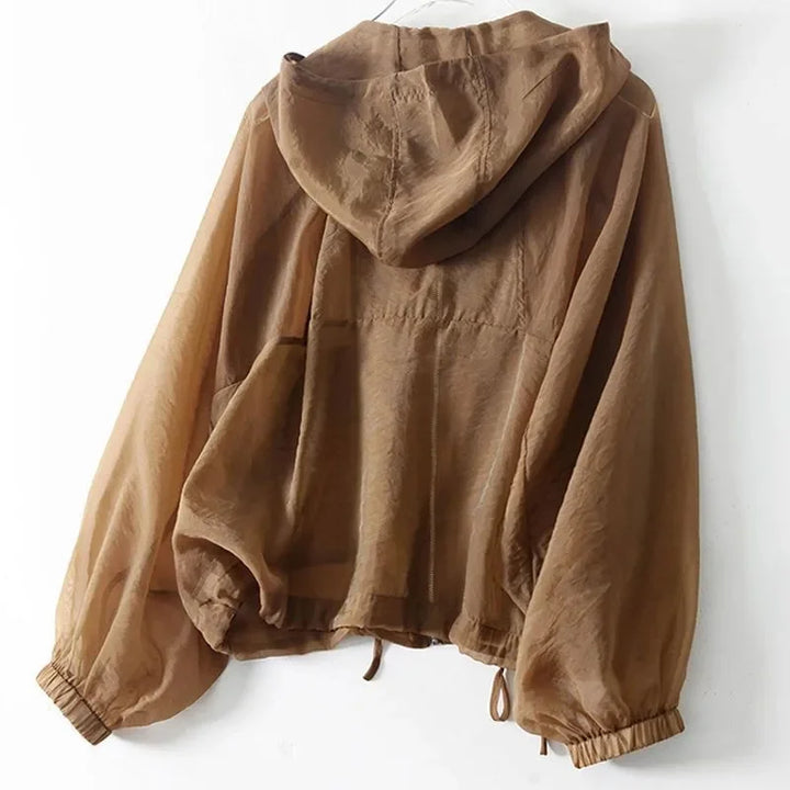 Comoda giacca impermeabile da donna marrone e bianca con cappuccio, perfetta per viaggio e casual.