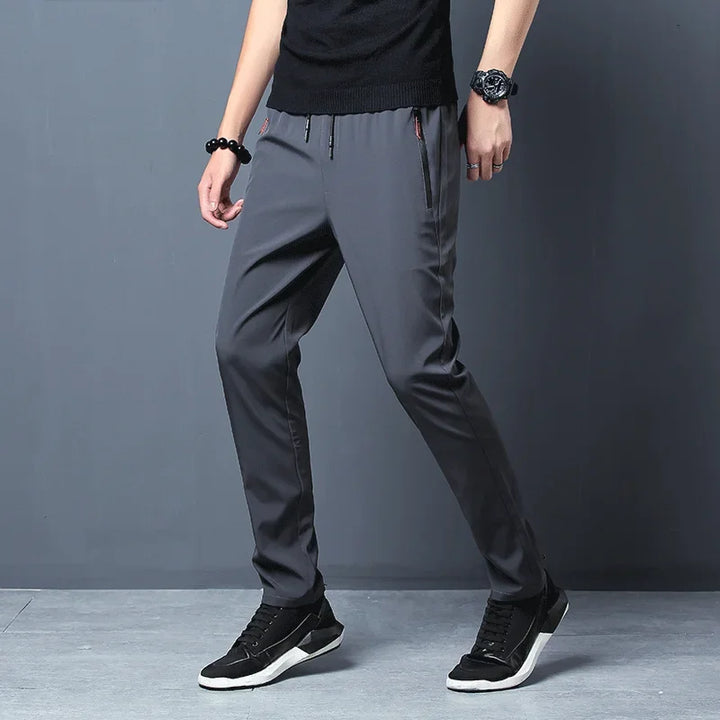 Pantaloni uomo slim fit eleganti casual, con vita elastica per comfort e tasche con zip sicure.