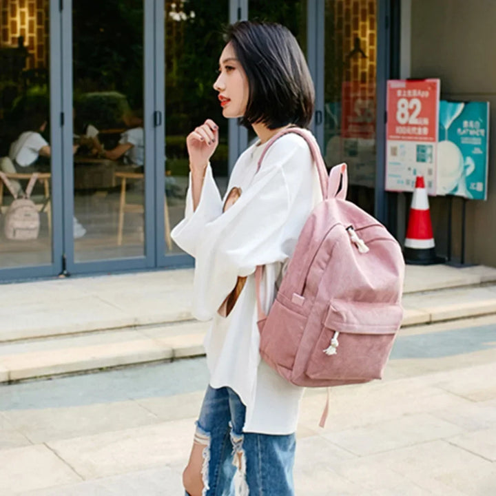 Zaino casual unisex in velluto a coste indossato, ideale come borsa scuola, per viaggi o tempo libero.