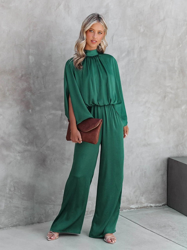 Tuta donna verde smeraldo con pantaloni ampi, ideale come vestito da cerimonia o abito da sera elegante.