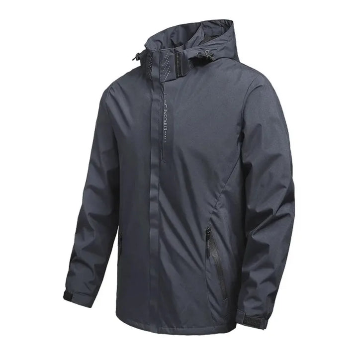 Dettaglio giacca softshell unisex grigia: cerniera resistente e tasche funzionali per abbigliamento esterno.