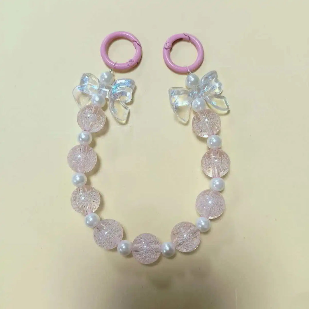 Accessorio telefono donna, laccetto con perline macaron e fiore, per avere sempre il tuo device a portata di mano.