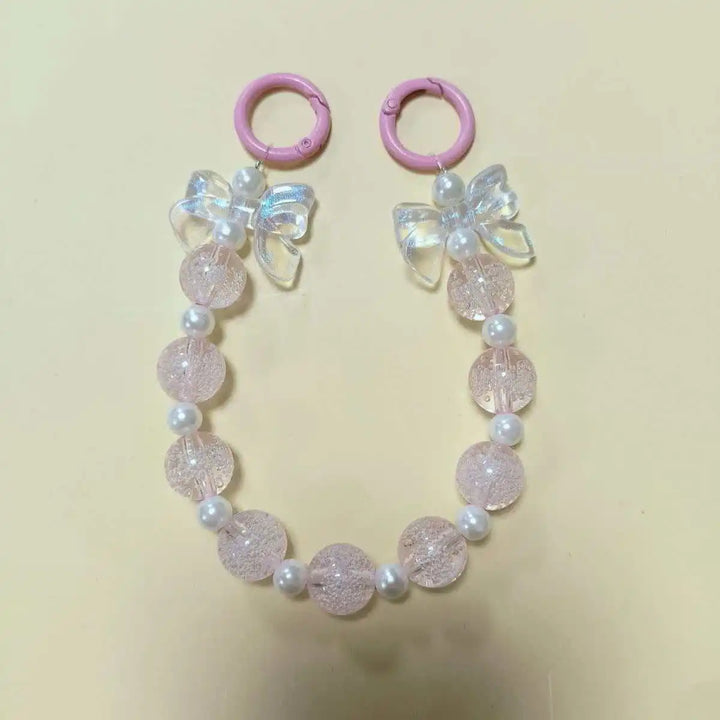 Accessorio telefono donna, laccetto con perline macaron e fiore, per avere sempre il tuo device a portata di mano.