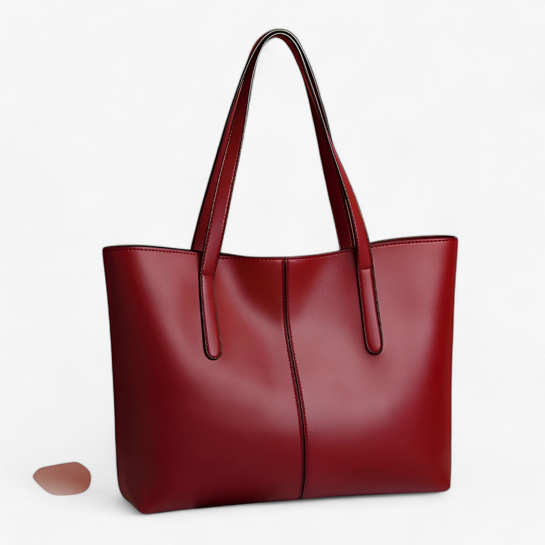Borsa tote rossa, elegante e capiente, perfetta per la donna moderna e i suoi accessori.