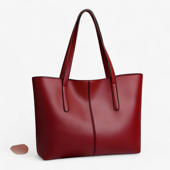 Borsa tote rossa, elegante e capiente, perfetta per la donna moderna e i suoi accessori.