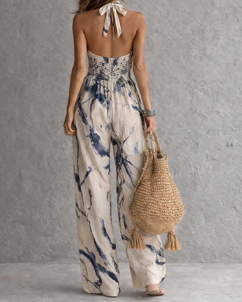 Abito intero donna estivo con stampa acquerello, scollo halter e silhouette fluida. Stile chic e leggero.