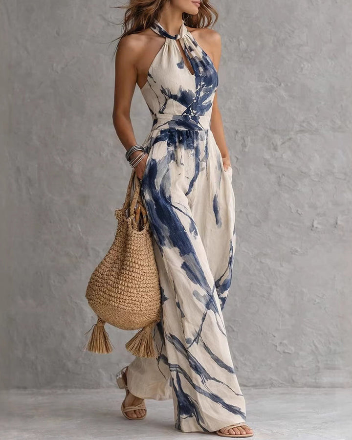 Tuta donna alla moda con stampa acquerello e pantaloni larghi. Ideale per un look raffinato e un comfort estivo.