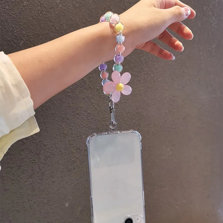 Elegante laccetto da polso donna per telefono, con perline macaron e fiore decorativo, molto chic.