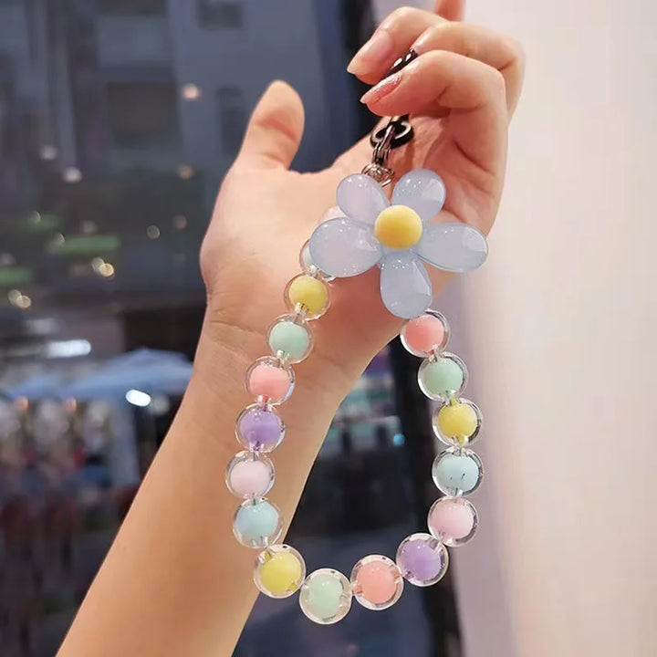 Laccetto telefono donna, design elegante con perline macaron e fiore, per ogni occasione speciale.