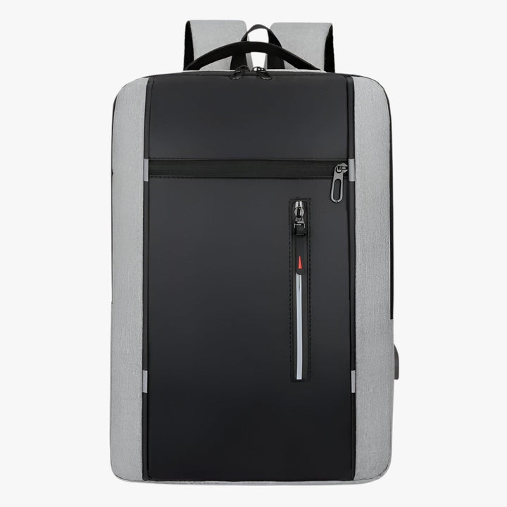Uomo che indossa uno zaino grigio casual porta laptop 15.6", pratico per università o tempo libero.