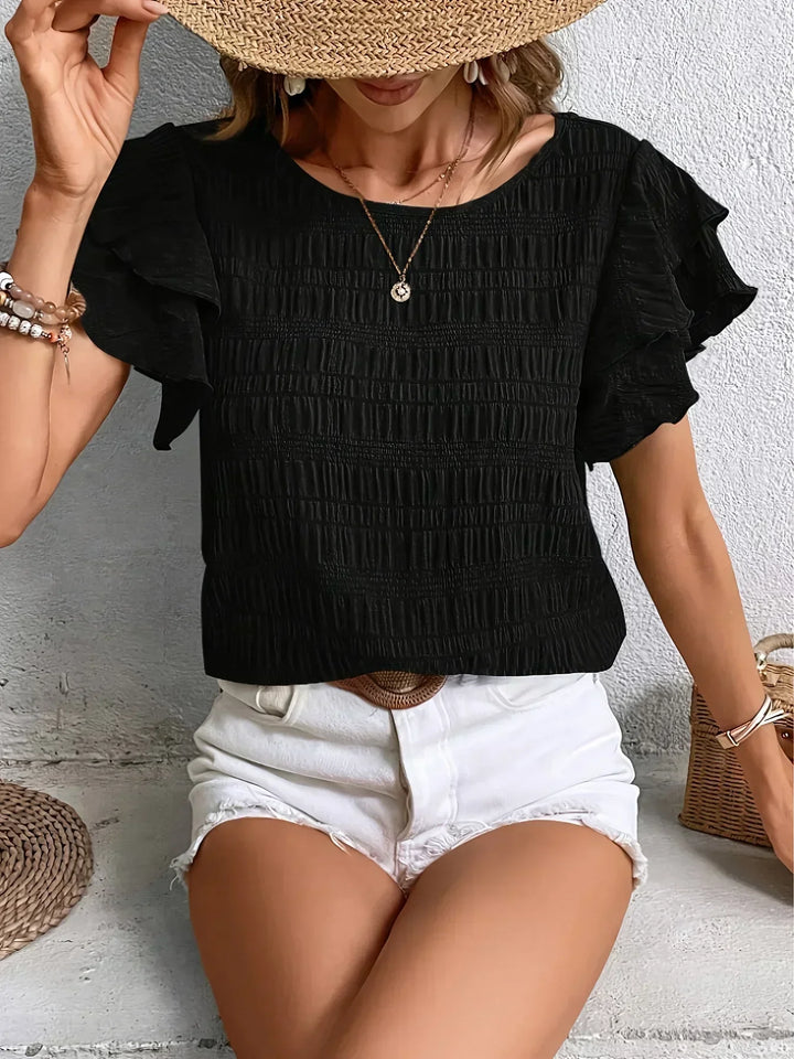 Blusa donna con volant, un capo essenziale della moda femminile, aggiunge grazia e stile.