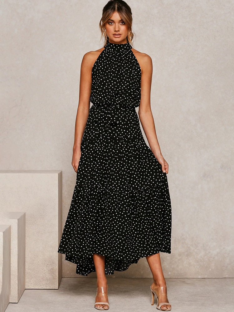 Abito midi svasato a pois, silhouette fluida con scollo all'americana. Abito estivo elegante e confortevole.