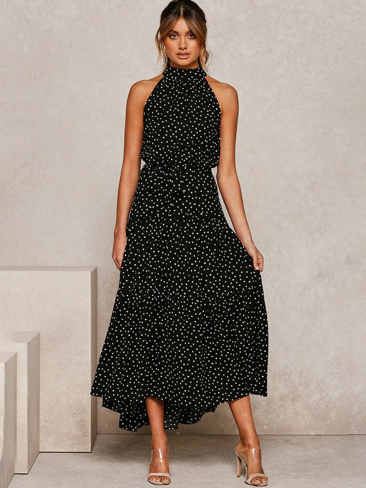Abito midi svasato a pois, silhouette fluida con scollo all'americana. Abito estivo elegante e confortevole.