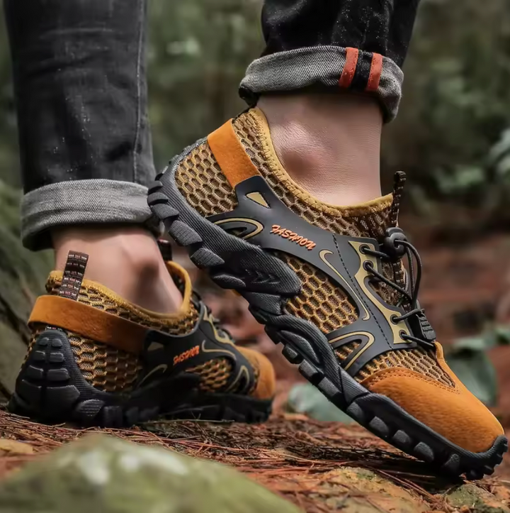 Scarpe da trekking uomo robuste per escursioni in montagna, con stabilità e aderenza antiscivolo su sentieri outdoor.