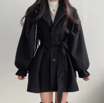 Elegante cappotto donna nero con cintura in vita e maniche a sbuffo, ideale per autunno/inverno. Stile chic.