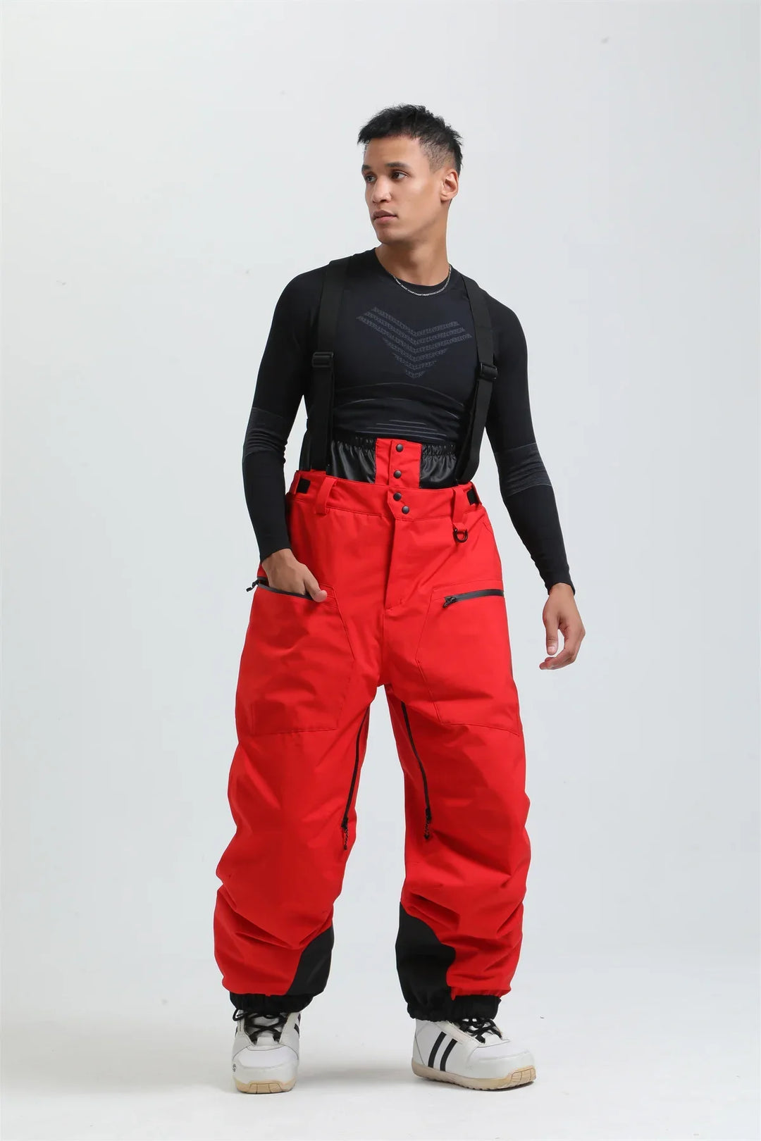 Pantaloni da sci unisex mimetici, impermeabili con bretelle, perfetti per affrontare il freddo intenso.