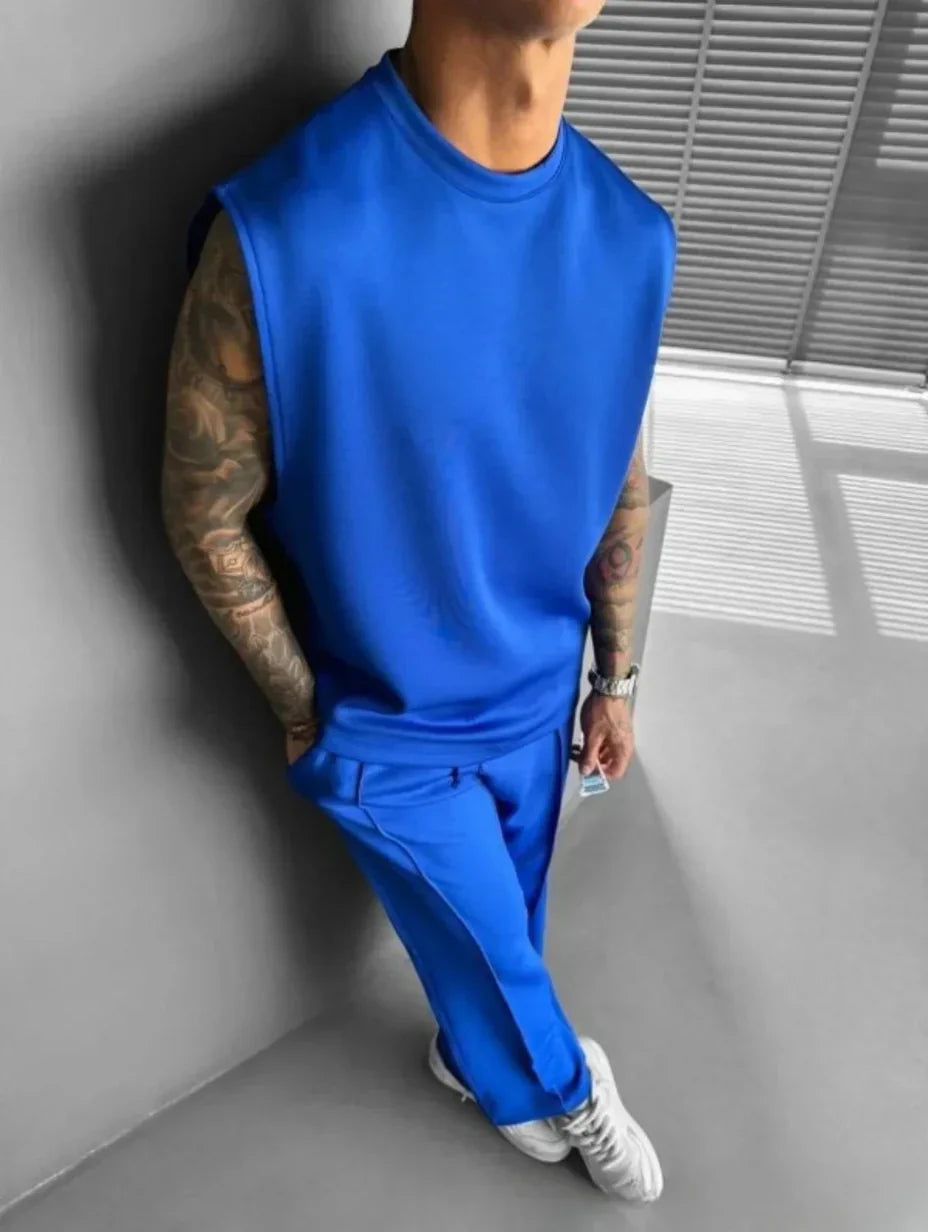 Completo uomo moderno, top senza maniche e pantaloni sartoriali, per un'estate di stile e relax.