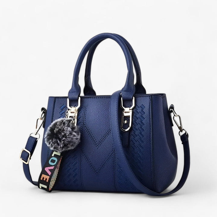 Borsa a mano donna chic da abbinare a look eleganti, con tracolla e pompon.