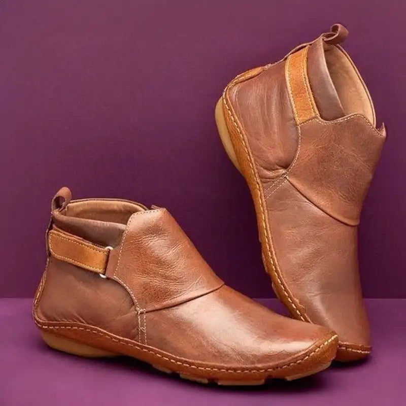 Stivaletti donna neri con cinturino laterale e suola flessibile, ideali per comfort moda autunno/inverno.