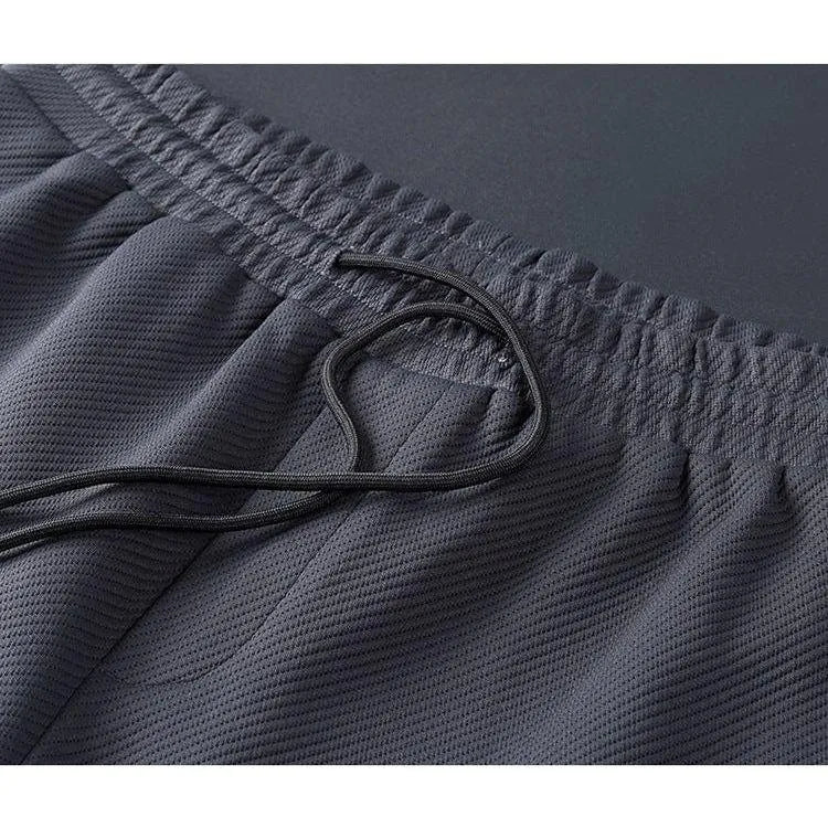 Dettaglio tessuto della tuta uomo premium, evidenziando qualità e vestibilità per un look athleisure.