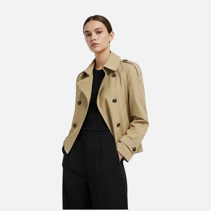Trench corto doppiopetto da donna con cintura, perfetto per un look elegante e casual chic autunnale.