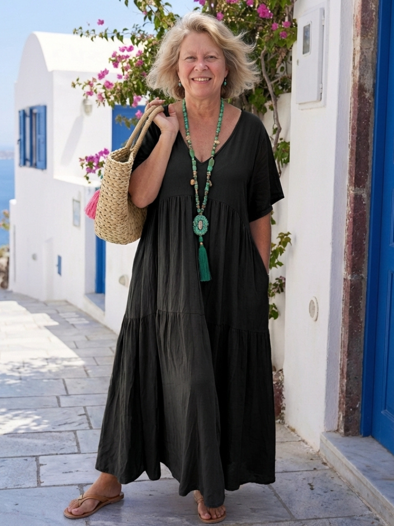 Abito da donna con balze decorative e maniche corte. Maxi dress femminile, versatile per look estivi e casual.