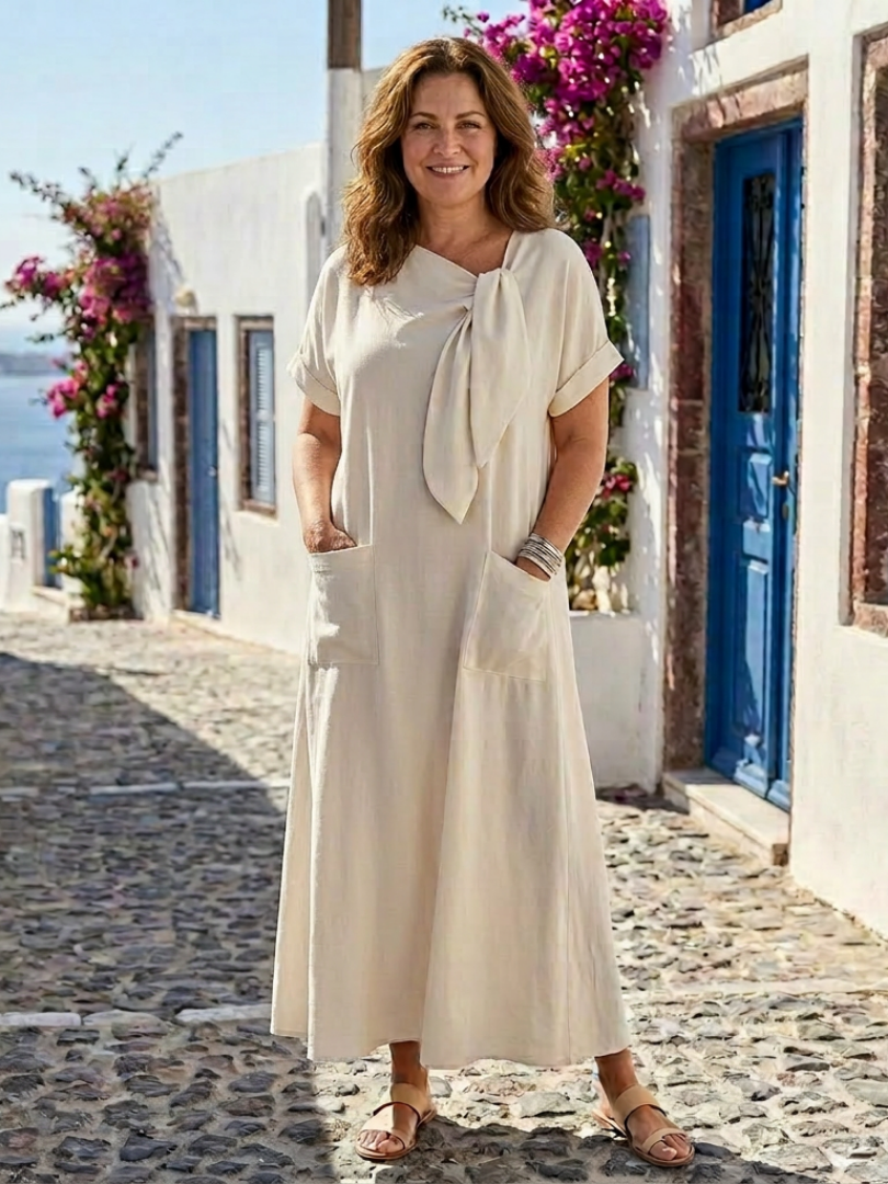 Abito maxi da donna fluido con maniche corte, collo rotondo e tasche laterali. Perfetto per look estivi casual.