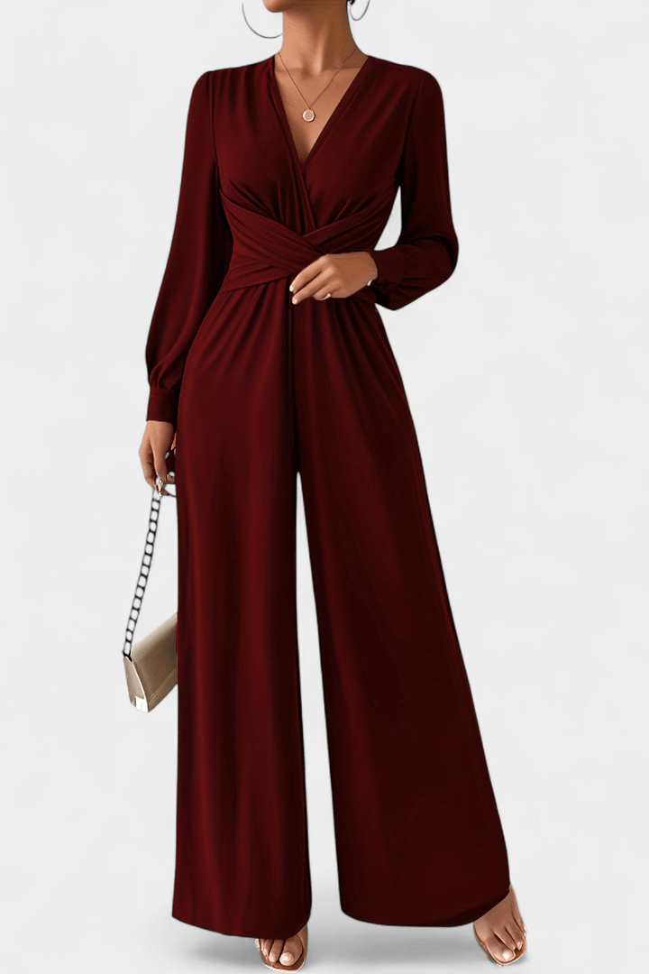 Tuta elegante donna nera con scollo a V profondo e vita drappeggiata, perfetta per sera e cerimonia.